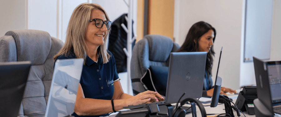 Danton HR team member typing on laptop in modern office